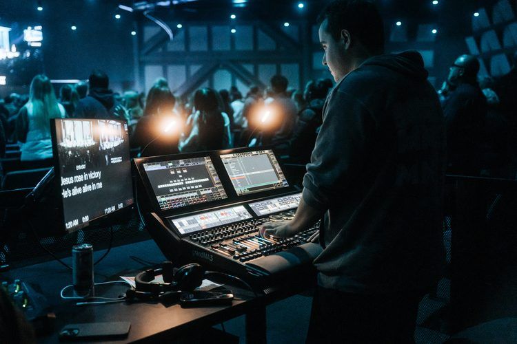 At front of house behind a grandMA console during a show