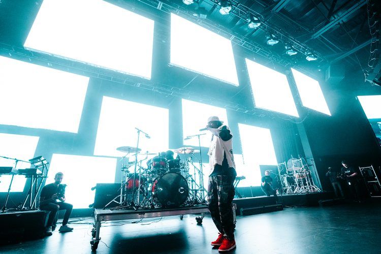 Band on a stage framed by tilted LED panels