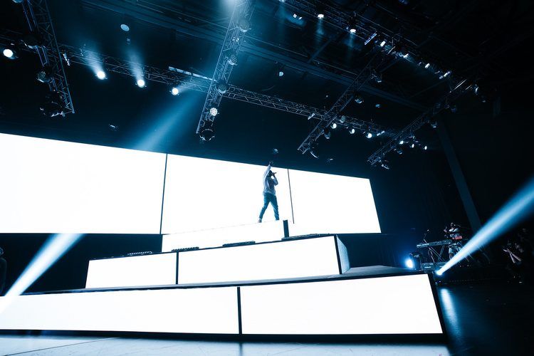 Performer on a white LED staircase set