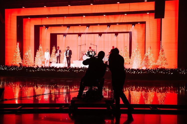 Deep red corridor of light framing the stage