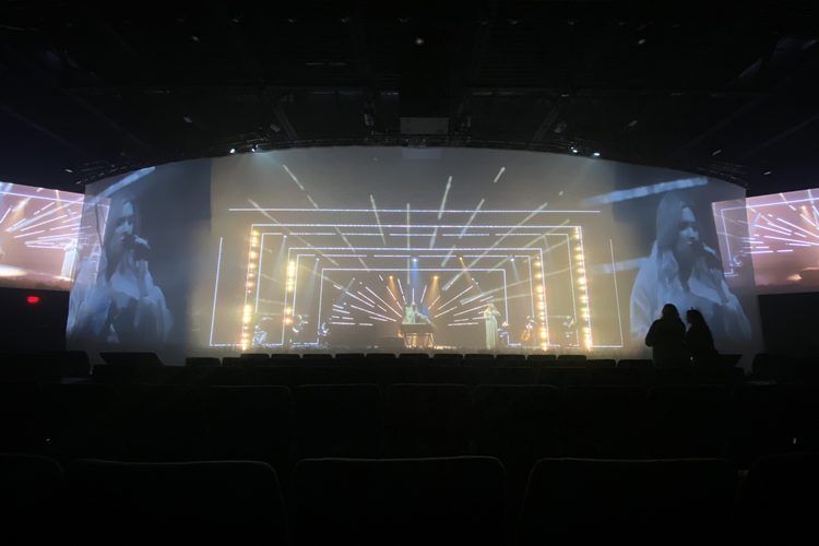 Low warm wash across a wide stage in a dark room